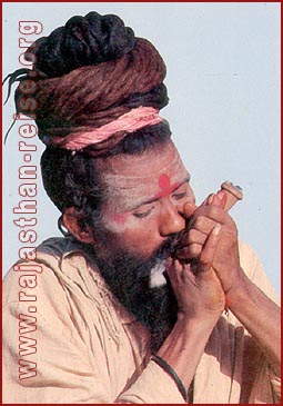 An ascetic smoking 'Chilam' in Ranakpur, Rajasthan